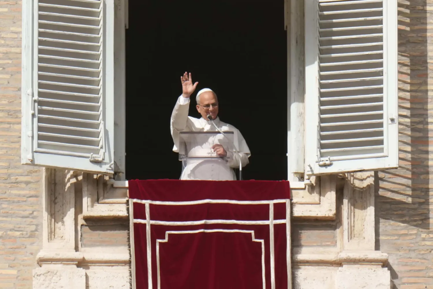 Pope Leo XIV delivers his blessing as he recites the Angelus noon prayer from the window of his studio overlooking St.Peter's Square, at the Vatican, Sunday, Oct. 26, 2025. (AP Photo/Alessandra Tarantino)