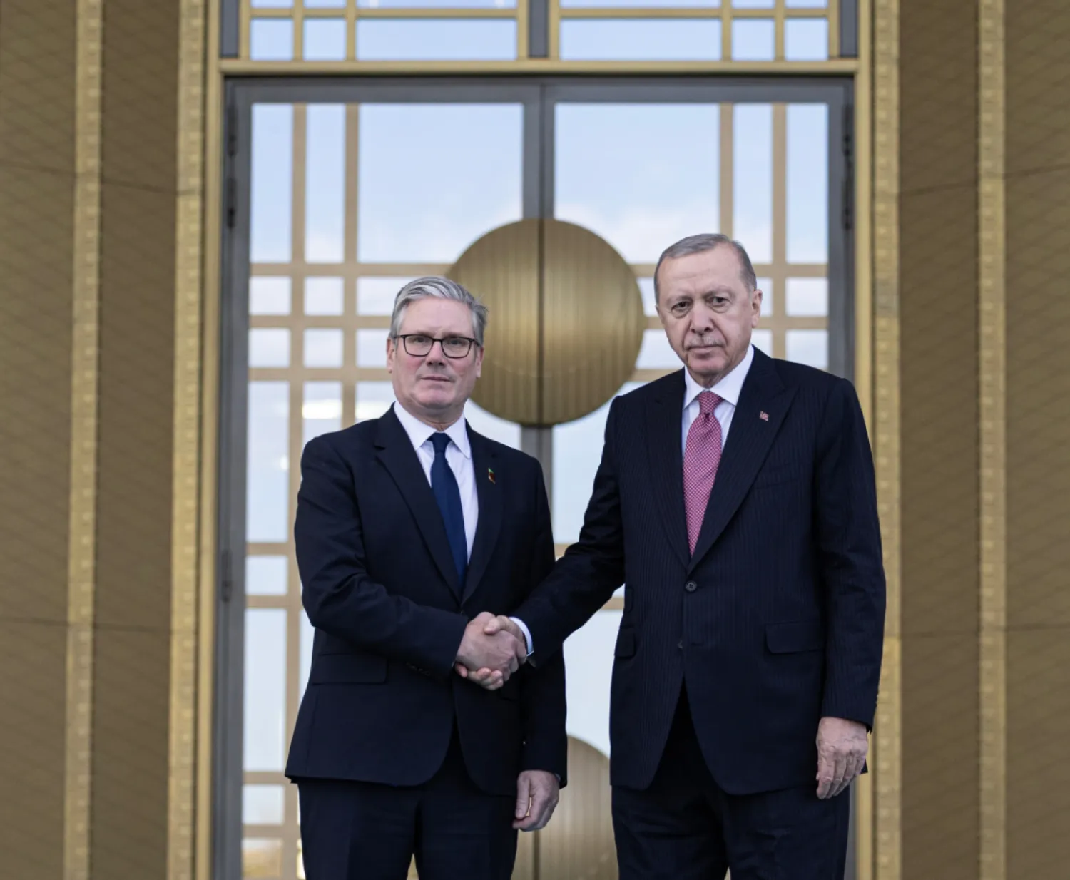 Turkish President Recep Tayyip Erdogan, right, and Britain's Prime Minister Keir Starmer shakes hands prior to their meeting at the presidential palace, in Ankara, Monday, Oct. 27, 2025. (Ugur Yildirim/Dia Photo via AP)
