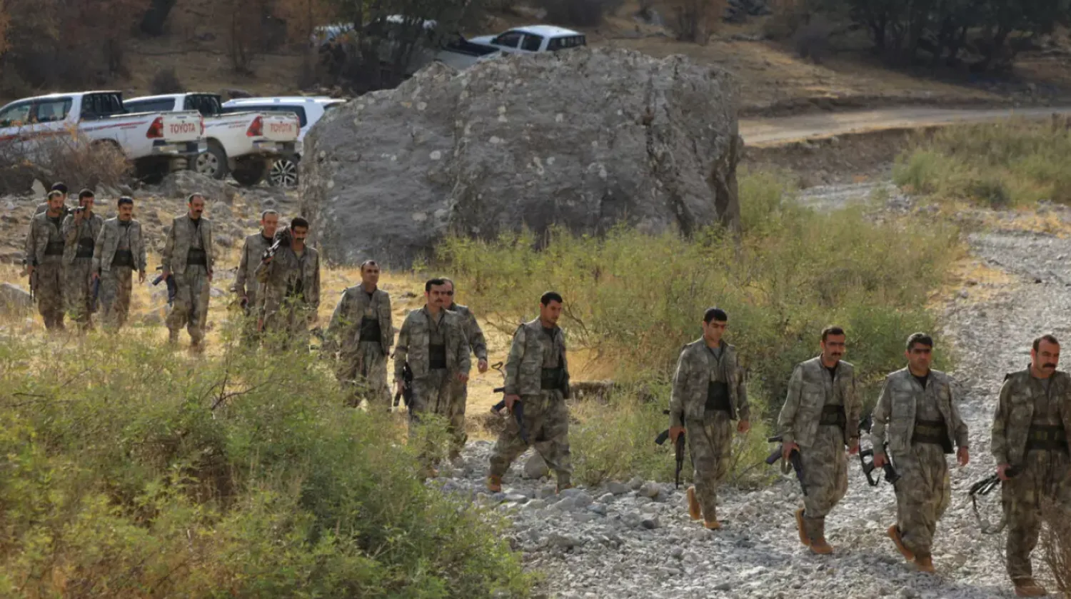 Fighters with the Kurdistan Workers' Party (PKK) walk for a disarmament ceremony marking a significant step toward ending the decades-long conflict between Türkiye and the outlawed group in the Qandil mountains, Iraq on October 26, 2025. © Thaier Al-Sudan, Reuters
