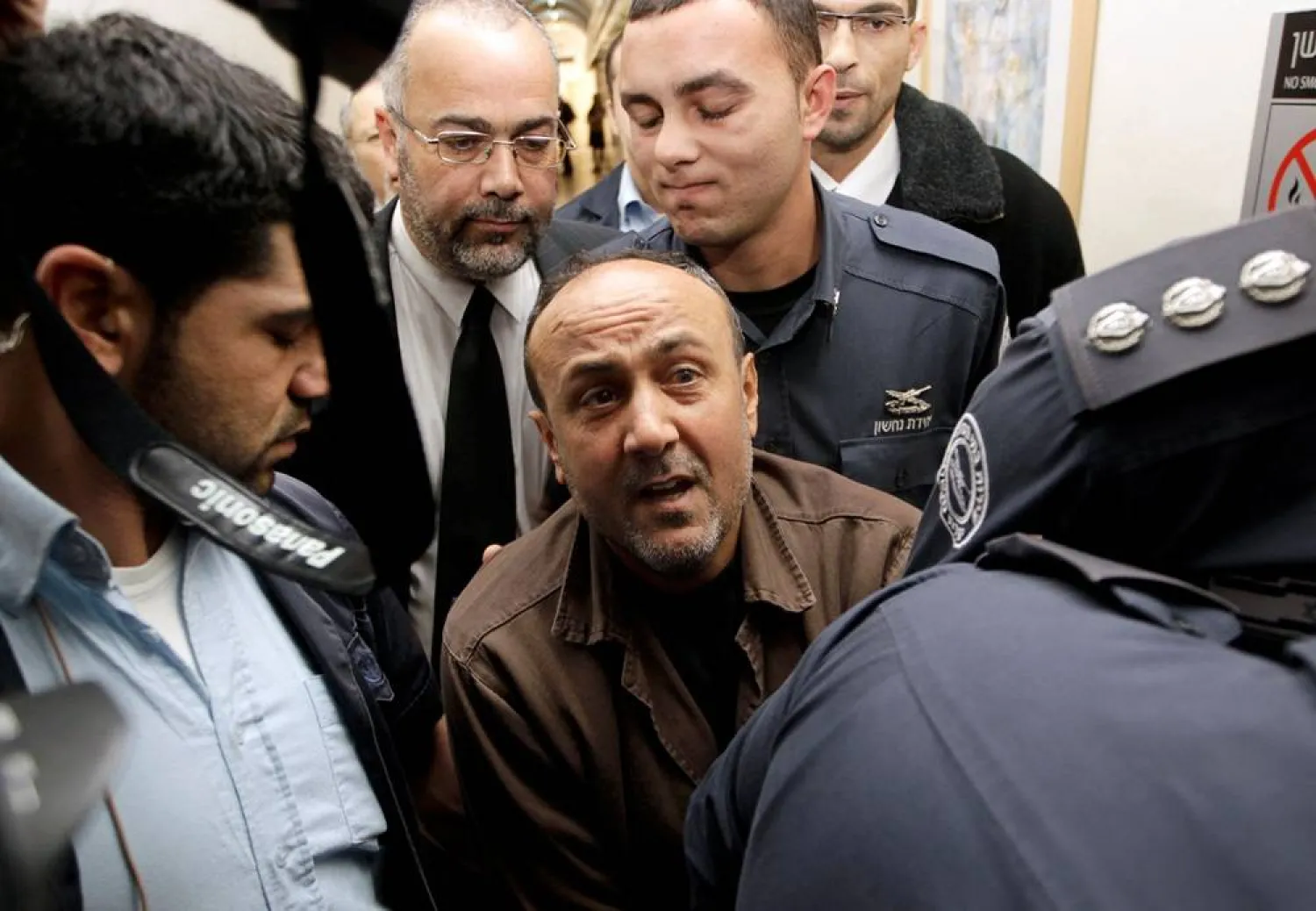 Jailed Fatah leader Marwan Barghouti (C) is accompanied by Israeli prison guards after a deliberation at Jerusalem Magistrate's court January 25, 2012. (Reuters)