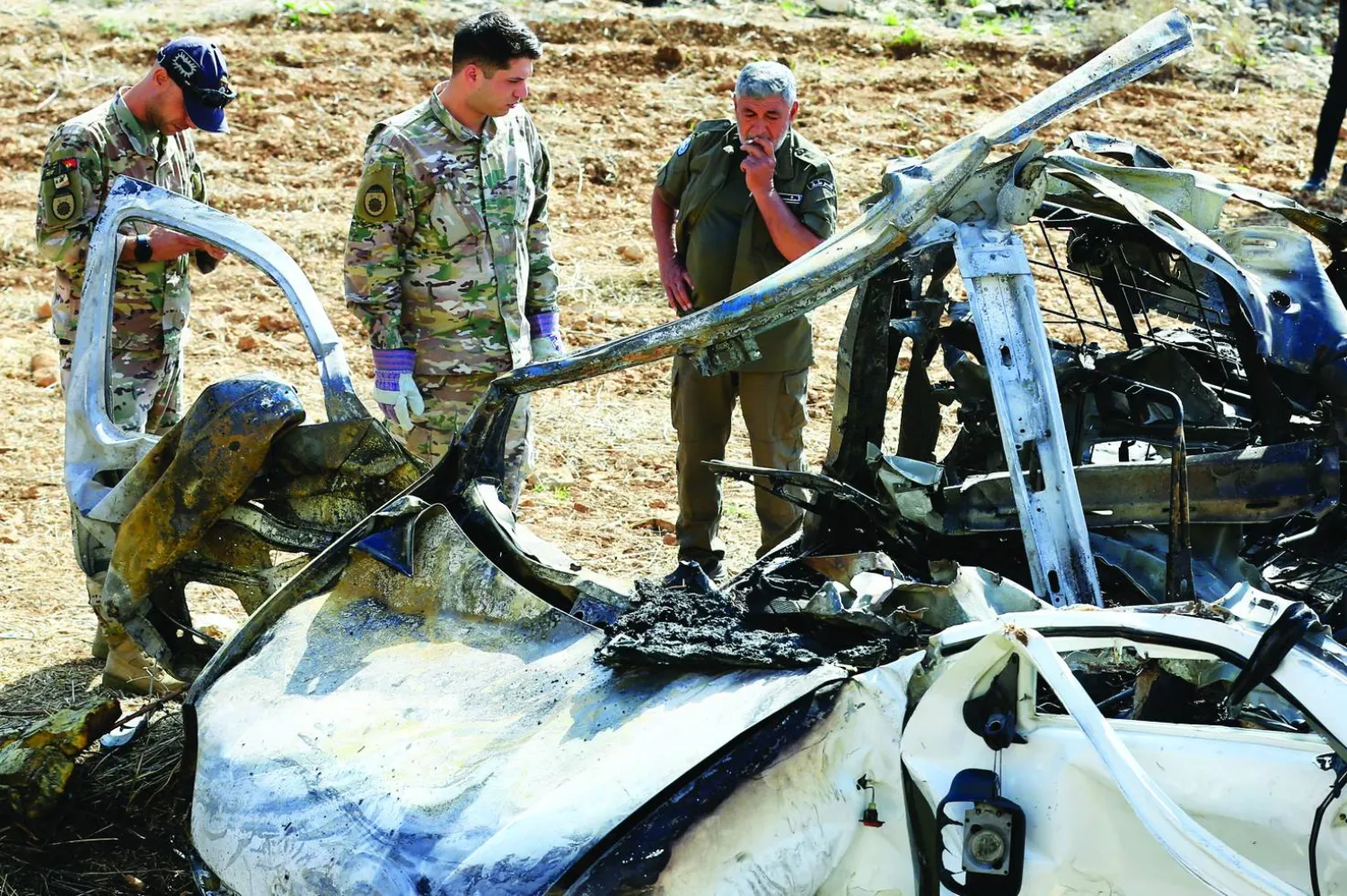 Lebanese army soldiers stand next to the wreckage of a vehicle targeted by an Israeli drone in the village of Harouf in the Nabatieh Governorate, southern Lebanon, 25 October 2025. EPA/STRINGER