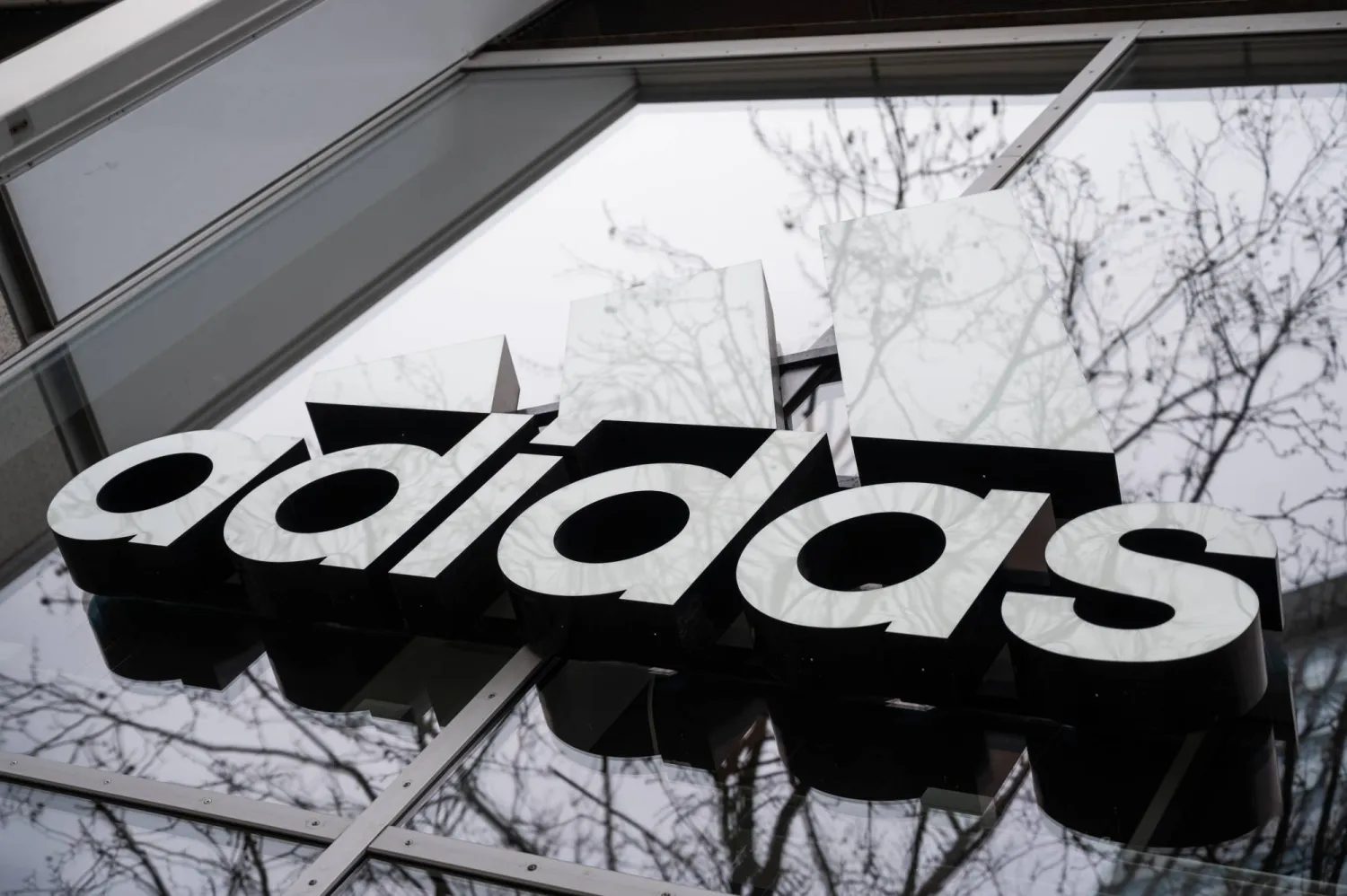 12 April 2021, Berlin: The Adidas logo is pictured on the façade of a building in Berlin. (dpa)