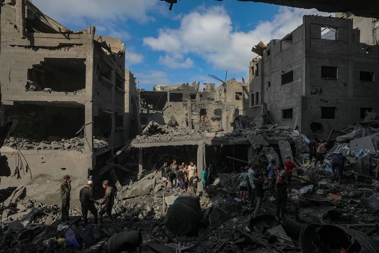 Palestinians observe the destruction following an Israeli airstrike targeting a residential block in Al Shatea refugee camp in Gaza City, 29 October 2025. (EPA)