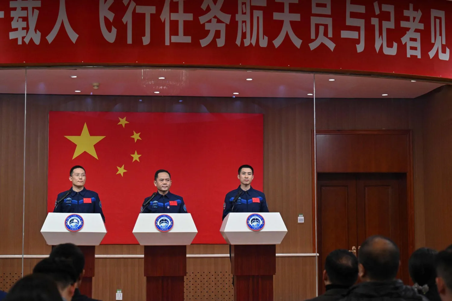 Astronauts for China's Shenzhou-21 space mission Zhang Hongzhang (L), Commander Zhang Lu (C) and Wu Fei (R) attend a press conference a day before the launch of the mission at the Jiuquan Satellite Launch Centre in the Gobi desert, in northwest China on October 30, 2025. (Photo by Hector RETAMAL / AFP)