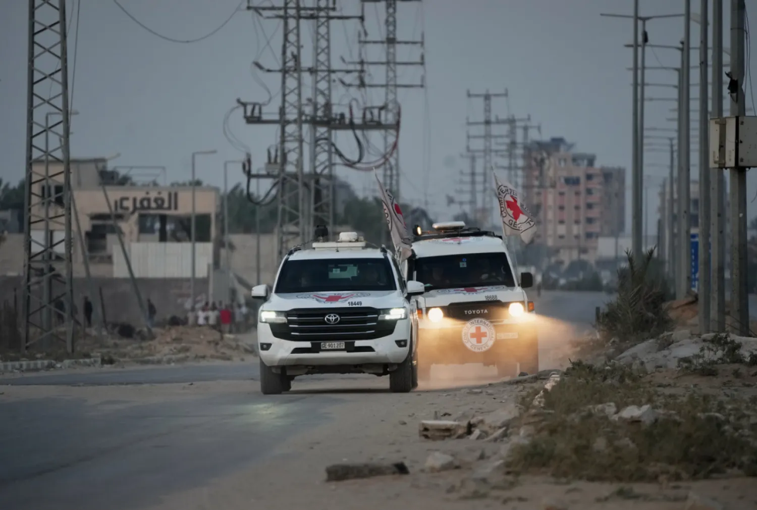 Red Cross vehicles carrying the bodies of two people believed to be deceased hostages handed over by Hamas make their way toward the Kissufim border crossing with Israel, to be transferred to Israeli authorities, in Deir al-Balah, central Gaza Strip, Thursday, Oct. 30, 2025. (AP Photo/Abdel Kareem Hana)