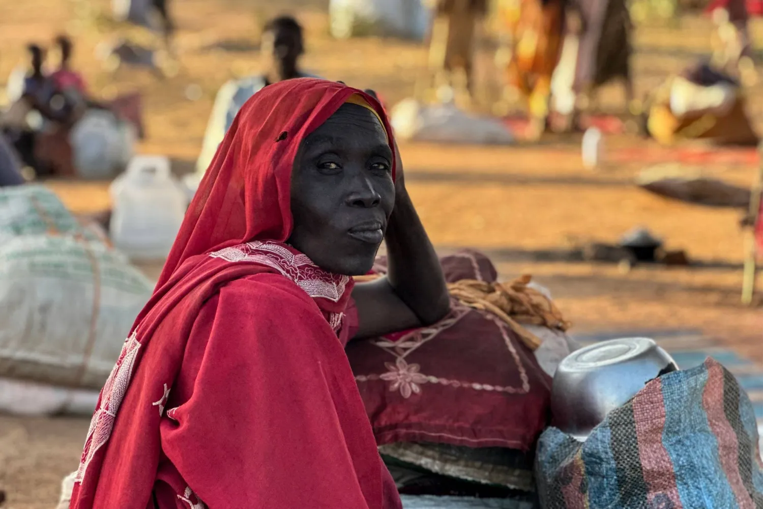 A displaced Sudanese woman who fled El-Fasher after the city fell to the RSF, rests in the town of Tawila in war-torn Sudan's western Darfur region on October 28, 2025. (Photo by AFP)