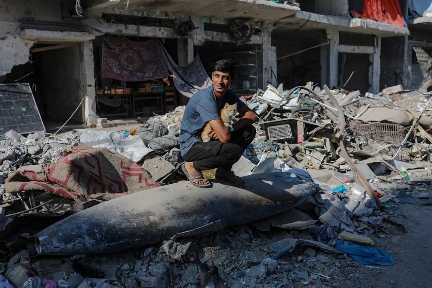 An Israeli missile lays on the rubble in the middle of a street next to destroyed houses in Gaza City, Gaza Strip, 30 October 2025, amid a ceasefire between Israel and Hamas. (EPA) 