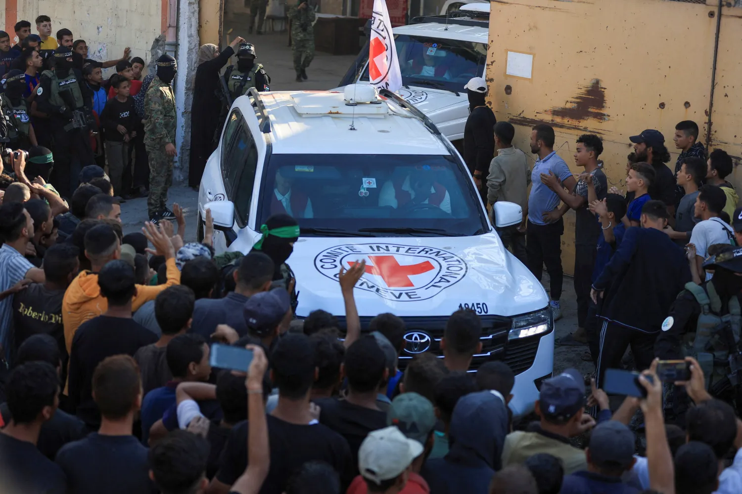 Red Cross vehicles transport hostages, held in Gaza since the deadly October 7, 2023 attack, following their handover as part of a ceasefire and hostages-prisoners swap deal between Hamas and Israel, in Gaza City October 13, 2025. REUTERS/Dawoud Abu Alkas