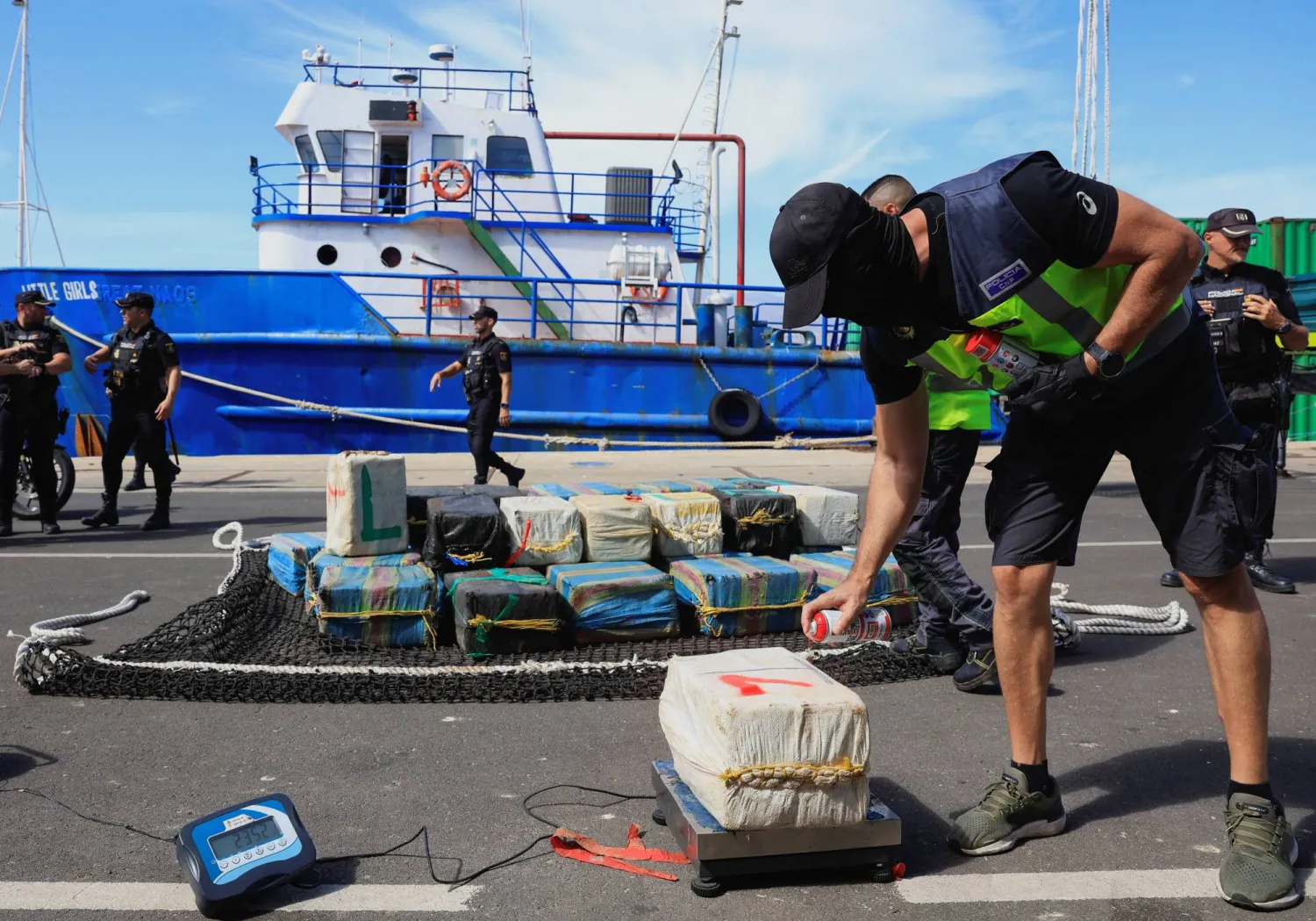 شرطي إسباني يضع علامة على رزمة من المخدرات في جزيرة غران كناريا (رويترز)