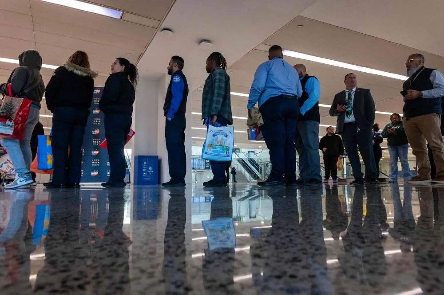 Federal workers, including Transportation Security Administration (TSA) officers and air-traffic controllers, line up to receive food parcels at Newark Liberty International Airport as the workers have been impacted by the government shutdown on October 27, 2025 in Newark, New Jersey. (Getty Images/AFP)