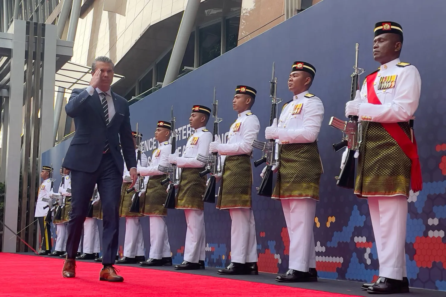 US Defense Secretary Pete Hegseth, left, walks in front of an honor guard as he arrives for the ASEAN Defense Ministers' Meeting - Plus in Kuala Lumpur, Malaysia, Saturday, Nov. 1, 2025. (AP Photo)
