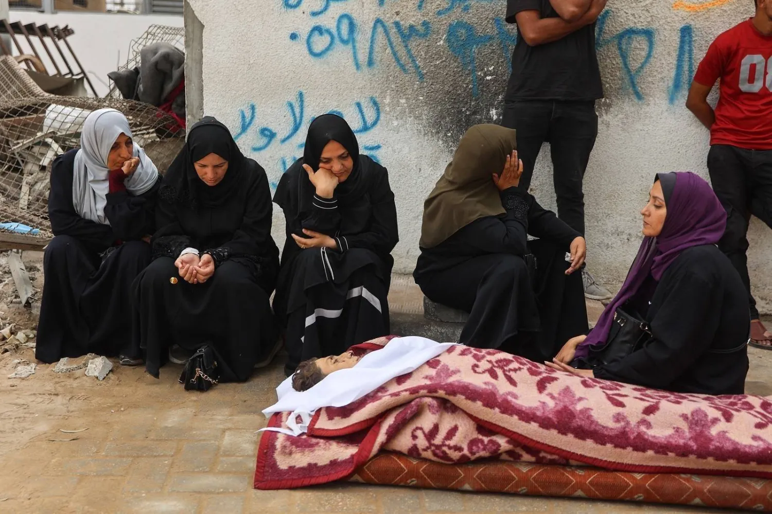 Palestinians mourn a relative killed in Israeli airstrikes in Gaza City (AFP)