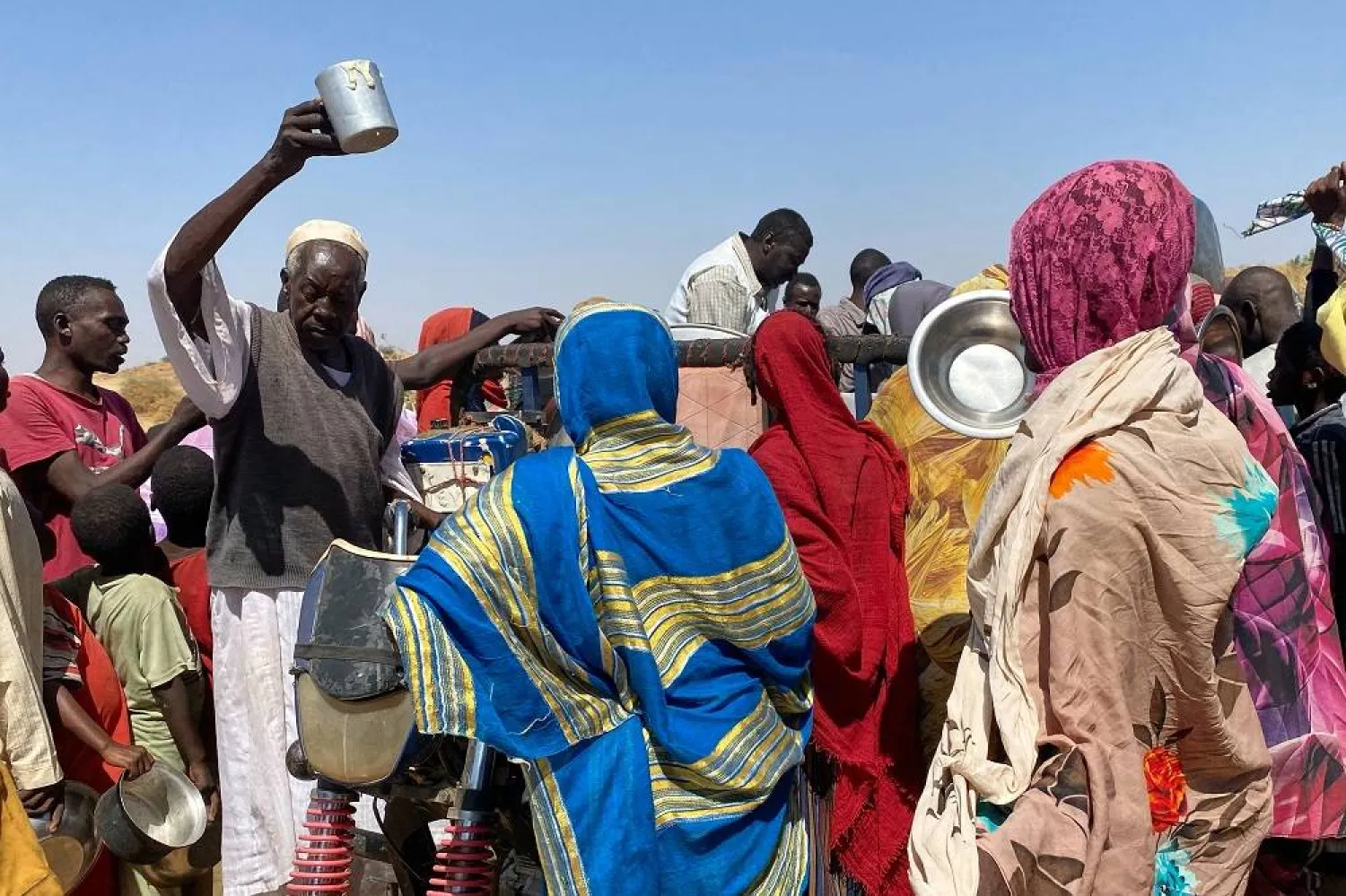Sudanese who fled el-Fasher city, after Sudan's RSF killed hundreds of people in the western Darfur region, crowd to receive food at their camp in Tawila, Sudan, Sunday, Nov. 2, 2025. (AP)