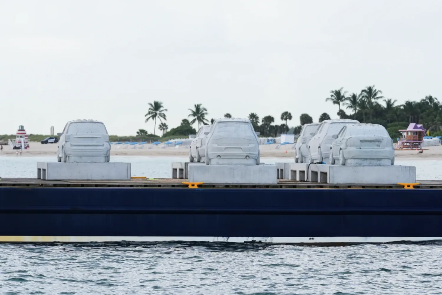 Concrete cars wait to the submerged off South Beach to become an underwater sculpture park Tuesday, Oct. 28, 2025, in Miami Beach, Fla. Native corals grown in a lab will be attached to the cars to create a reef. (AP Photo/Marta Lavandier)
