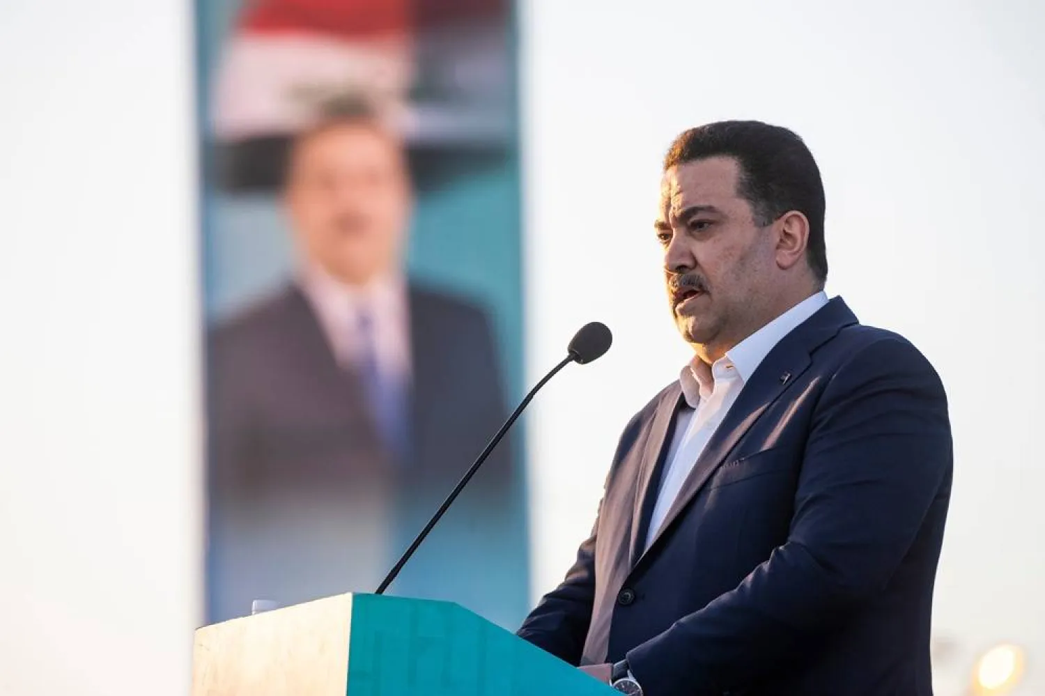 Prime Minister Mohammed Shia al-Sudani speaks to supporters during his political block campaign rally before the parliamentary elections in Najaf, Iraq, Sunday, Nov. 2, 2025. (AP)