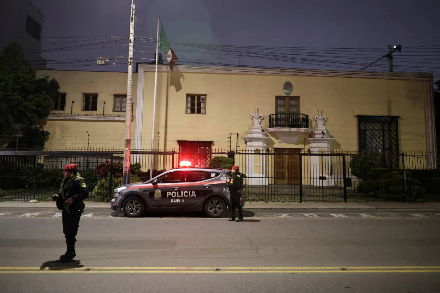 Members of the Peruvian police stand near a police patrol vehicle outside Mexico's Embassy, after Peru cut diplomatic ties with Mexico following Peru's former Prime Minister Betssy Chávez taking shelter in the embassy to request asylum, in Lima, Peru, November 3, 2025. (Reuters)