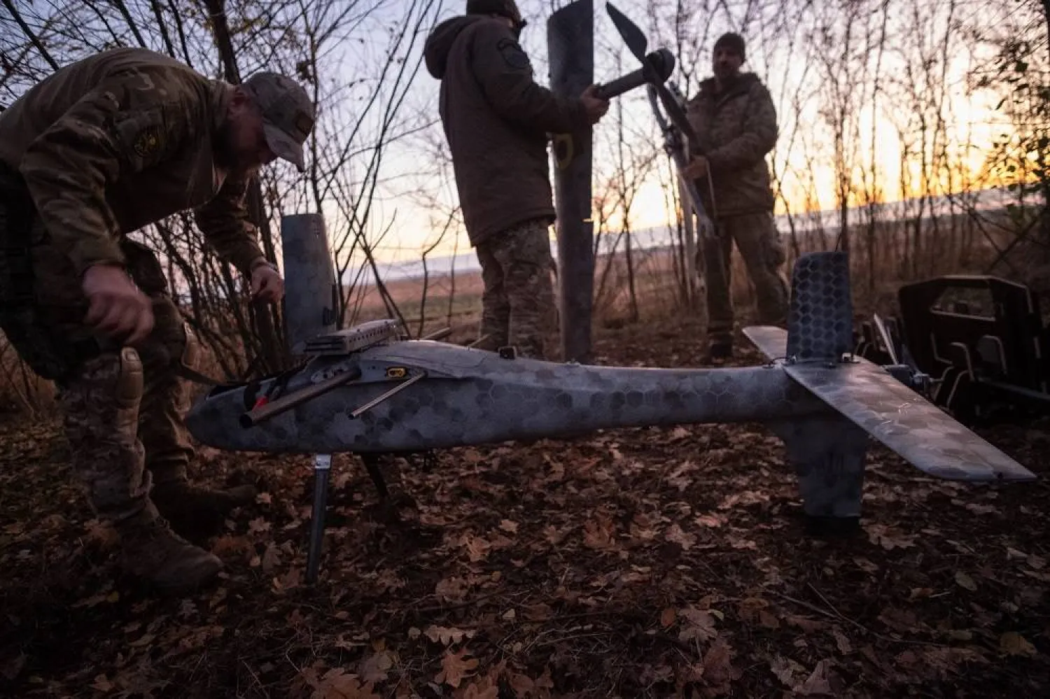 Pilots from the Predator Brigade's unmanned vehicle unit of the Ukrainian Patrol Police in Donetsk assemble a GARA bomber drone on a nighttime strike mission against Russian forces on the Pokrovsk front line, Ukraine, 02 November 2025. (EPA)