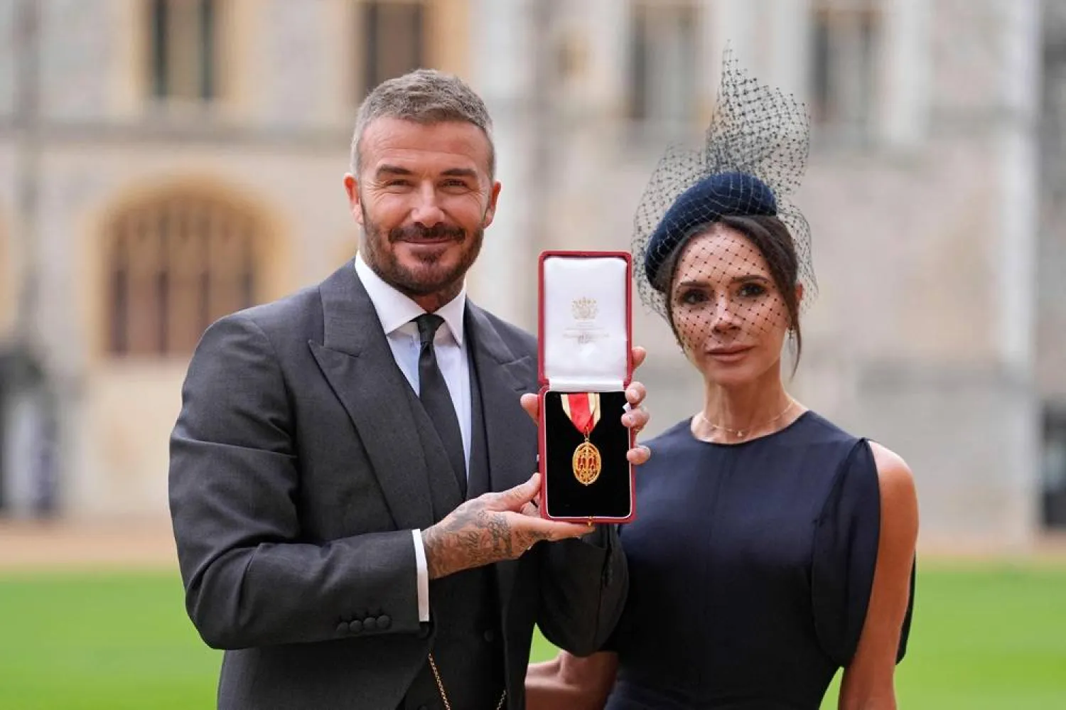  Former England footballer David Beckham (L) poses next to his wife singer and fashion designer Victoria Beckham (R) with his medal after being appointed as a Knight Bachelor (Knighthood) for services to sport and charity at an investiture ceremony at Windsor Castle on November 4, 2025. (AFP) 