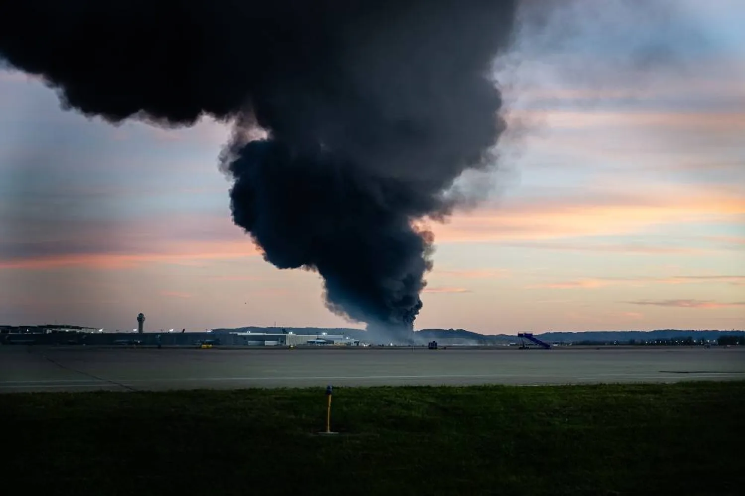 A plume of smoke rises from the site of a UPS cargo plane crash at Louisville Muhammad Ali International Airport on Tuesday, Nov. 4, 2025, in Louisville, Kentucky. (AP) 