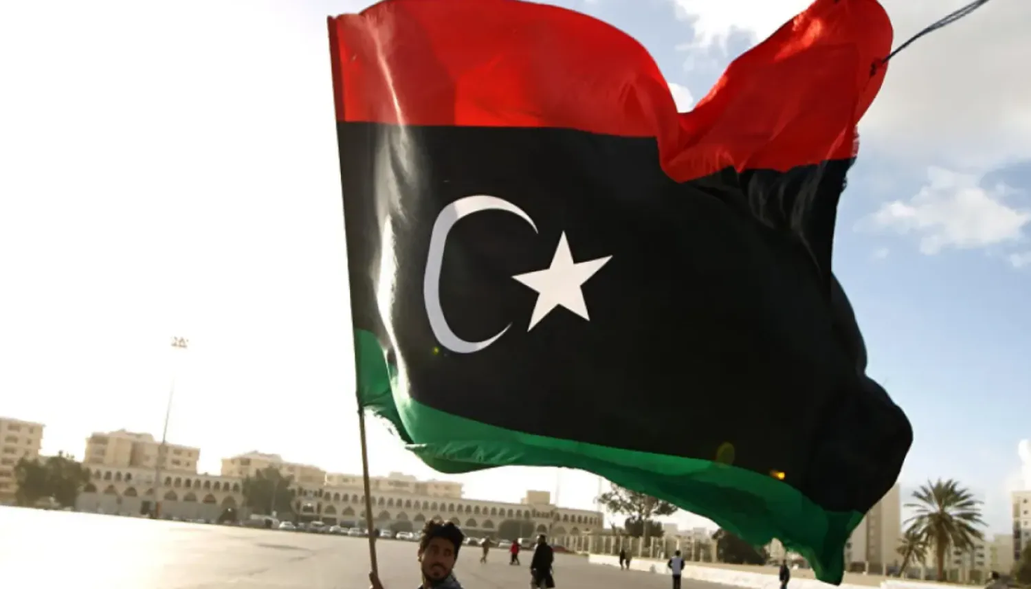Man waving the Libyan flag - File Photo/AFP

