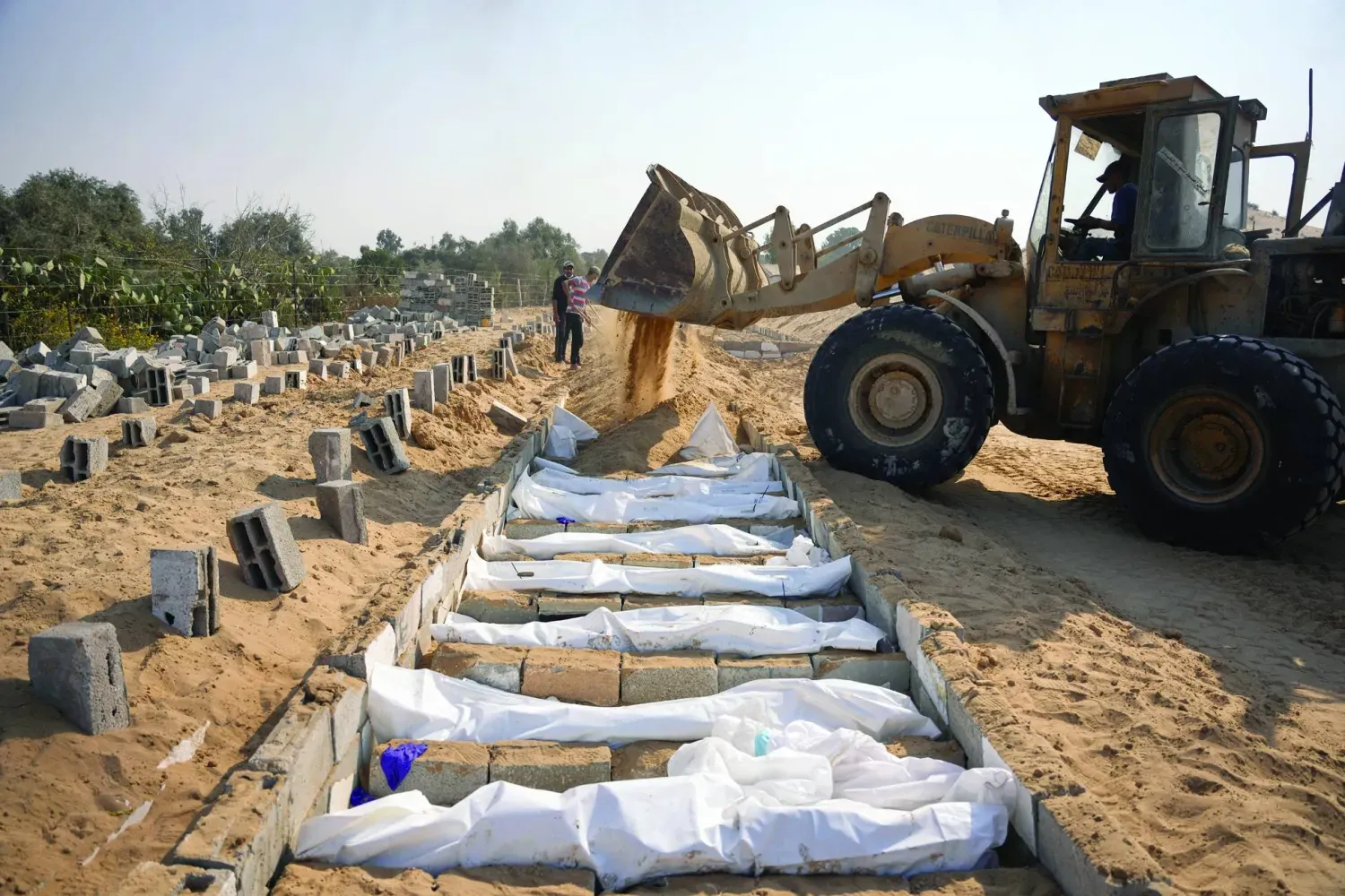 İsrail'in ateşkes anlaşması kapsamında teslim ettiği kimliği belirsiz Filistinlilerin cenazeleri dün Gazze Şeridi'ndeki Deyr el-Belah'ta toprağa verildi (AP).