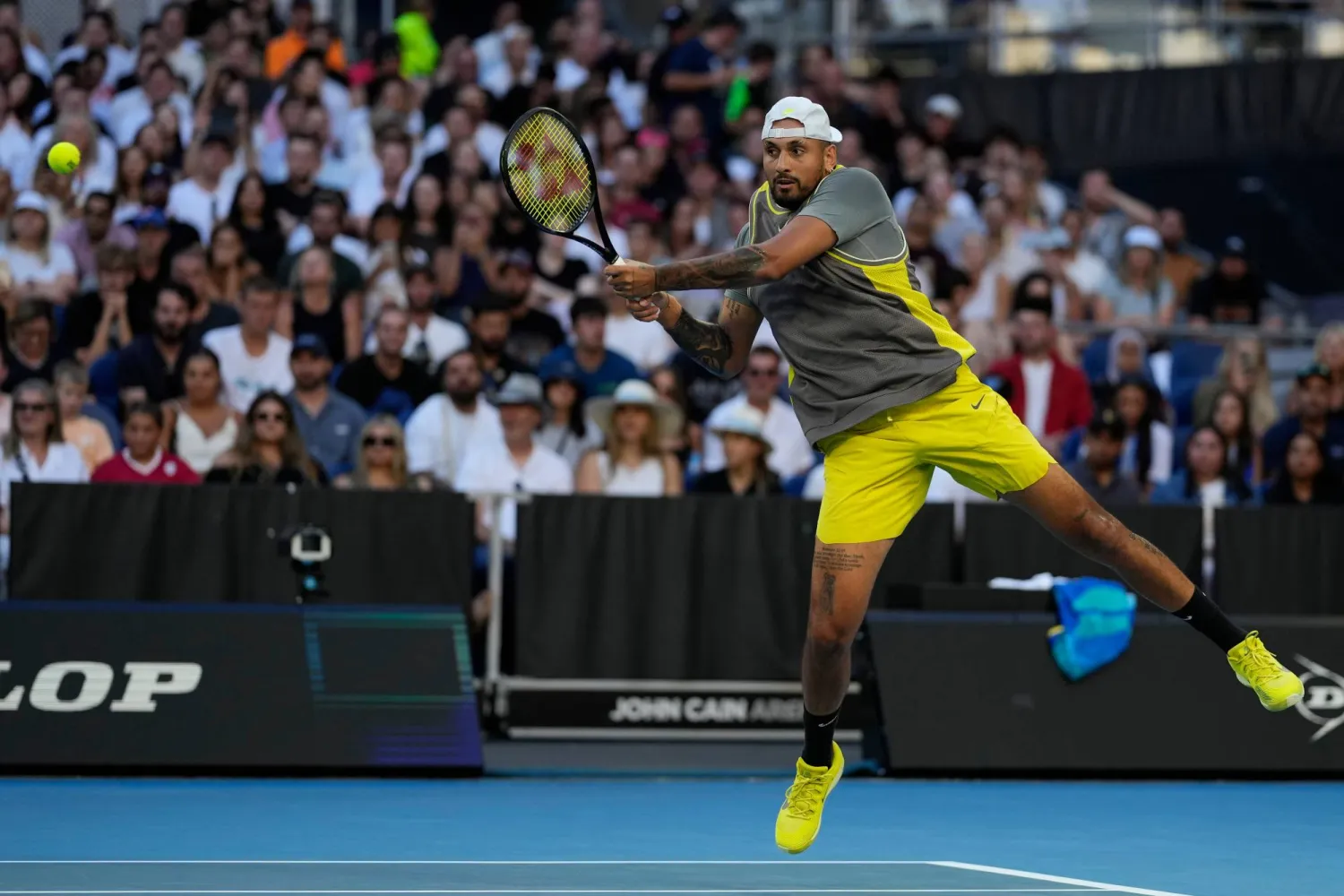 FILE - Nick Kyrgios of Australia plays a backhand return to Jacob Fearnley of Britain during their first round match at the Australian Open tennis championship in Melbourne, Australia, Monday, Jan. 13, 2025. (AP Photo/Ng Han Guan, file)