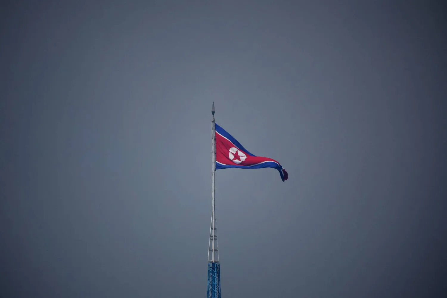FILE PHOTO: A North Korean flag flutters at the propaganda village of Gijungdong in North Korea, in this picture taken near the truce village of Panmunjom inside the demilitarized zone (DMZ) separating the two Koreas, South Korea, July 19, 2022.    REUTERS/Kim Hong-Ji/Pool/File Photo