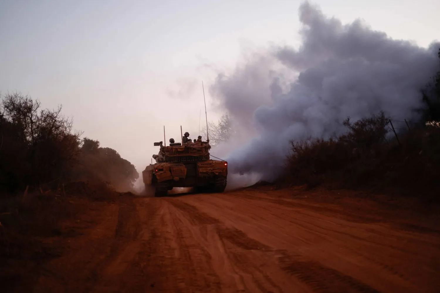 Israeli soldiers ride in the Merkava main battle tank at a position in northern Israel along the border with southern Lebanon on November 6, 2025. (Photo by Jalaa MAREY / AFP)