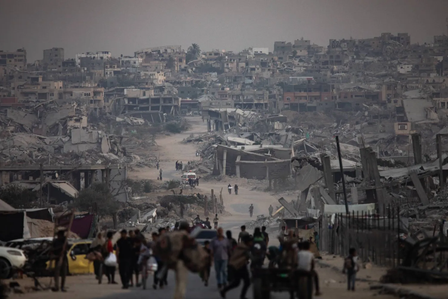 Displaced Palestinians sit next to their destroyed homes in Khan Yunis camp in the southern Gaza Strip, 05 November 2025. EPA/HAITHAM IMAD