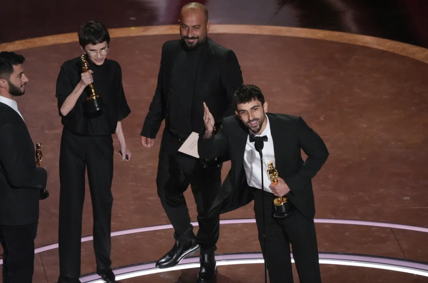 Basel Adra, from left, Rachel Szor, Hamdan Ballal, and Yuval Abraham accept the award for best documentary feature film for "No Other Land" during the Oscars on Sunday, March 2, 2025, at the Dolby Theatre in Los Angeles. (AP Photo/Chris Pizzello)