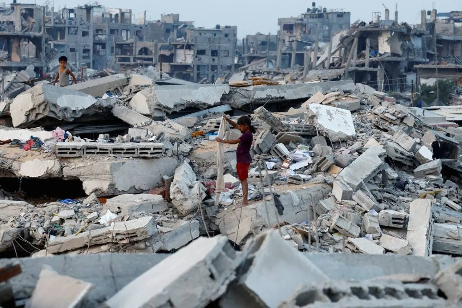  Palestinians stand on the rubble of destroyed buildings, amid a ceasefire between Israel and Hamas, in Jabalia, northern Gaza Strip, November 6, 2025. (Reuters)