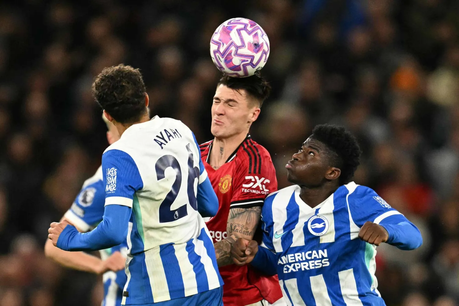 Manchester United's Slovenian striker #30 Benjamin Sesko (C) is challenged by Brighton's Swedish midfielder #26 Yasin Ayari (L) and Brighton's Cameroonian midfielder #17 Carlos Baleba (R) during the English Premier League football match between Manchester United and Brighton and Hove Albion at Old Trafford in Manchester, north west England, on October 25, 2025. (Photo by Oli SCARFF / AFP) 