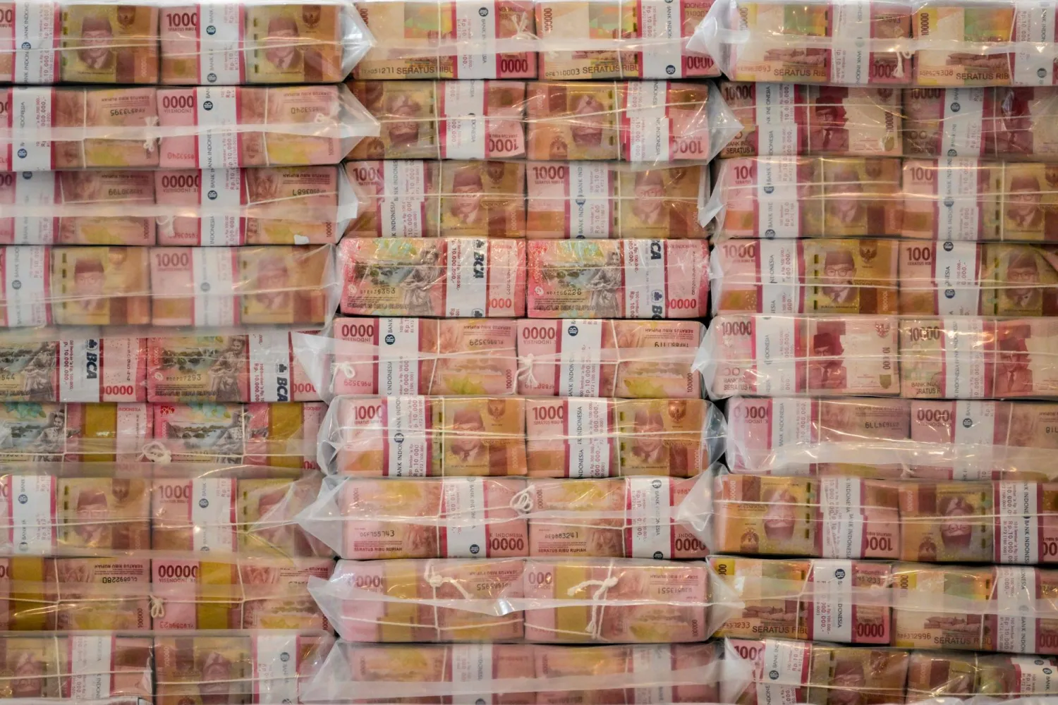Stacks of Indonesian rupiah banknotes equivalent to 800 million USD is displayed in the lobby of the Attorney General's Office building during the handover of assets recovered from the corruption case involving the provision of Crude Palm Oil export facilities, in Jakarta on October 20, 2025. (Photo by BAY ISMOYO / AFP)