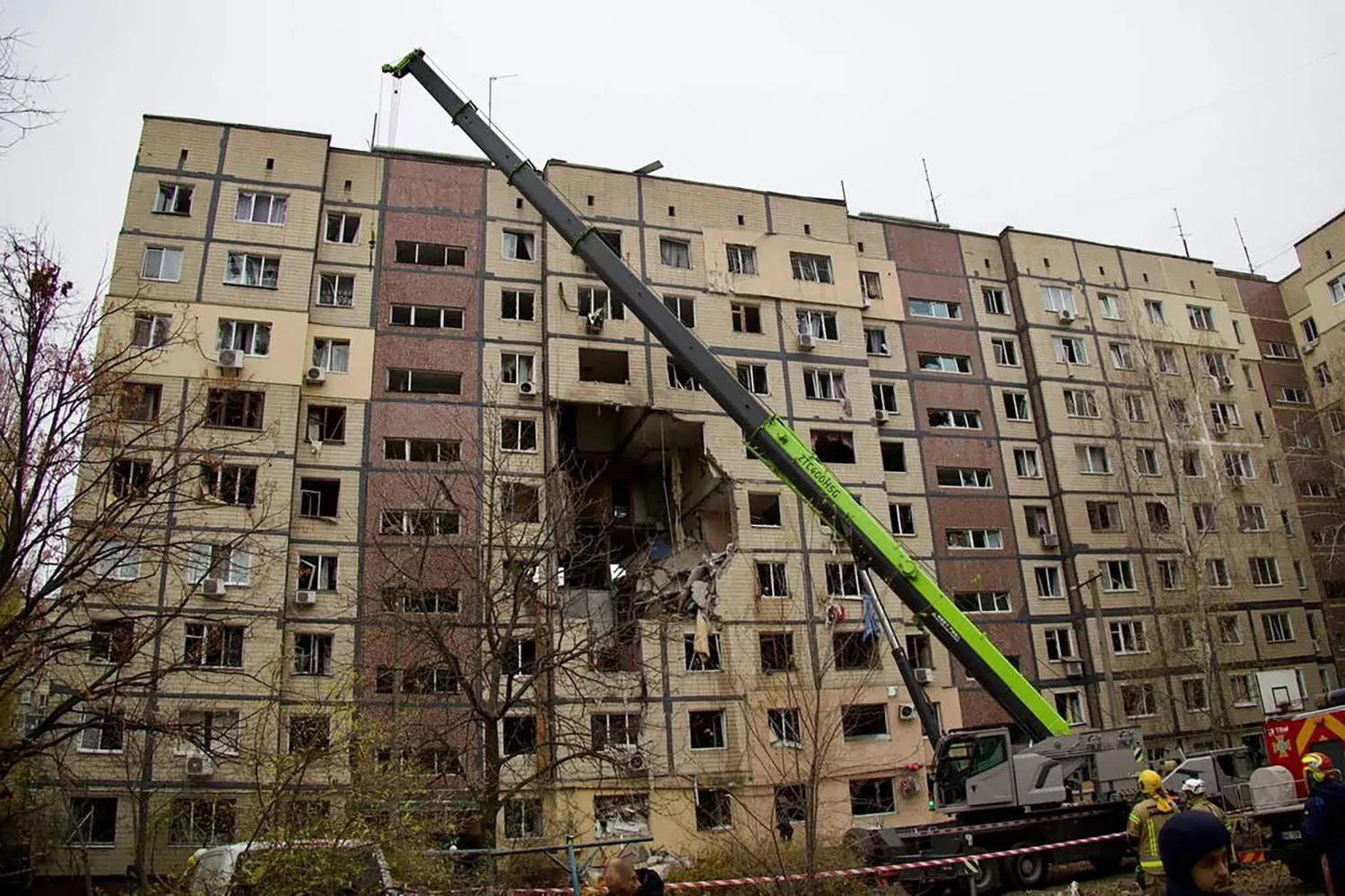 In this handout photograph taken and released by the Dnipropetrovsk Regional Military Administration on November 8, 2025, Ukrainian rescuers work at the site of a heavily damaged residential building following an air attack in Dnipro, amid the Russian invasion of Ukraine. (Photo by Handout / Dnipropetrovsk Regional Military Administration / AFP)