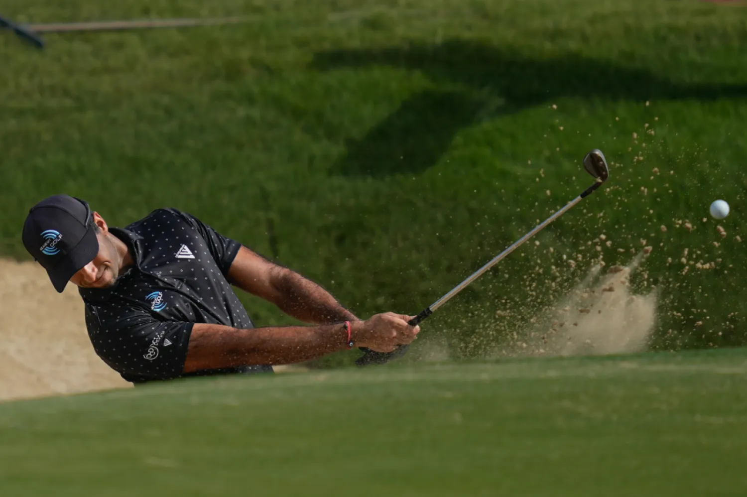 Aaron Rai of England hits a shot from a bunker on the 7th hole during the third round of the Abu Dhabi Golf Championship in Abu Dhabi, United Arab Emirates, Saturday, Nov. 8, 2025. (AP Photo/Altaf Qadri)