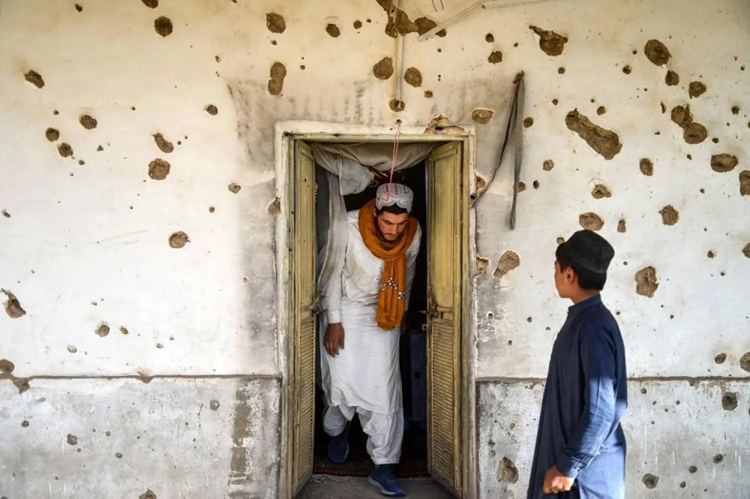 An Afghan man inspects a damaged house, following cross-border fire from Pakistan's artillery shelling, at a village in the Spin Boldak district of Kandahar on November 7, 2025. (AFP)
