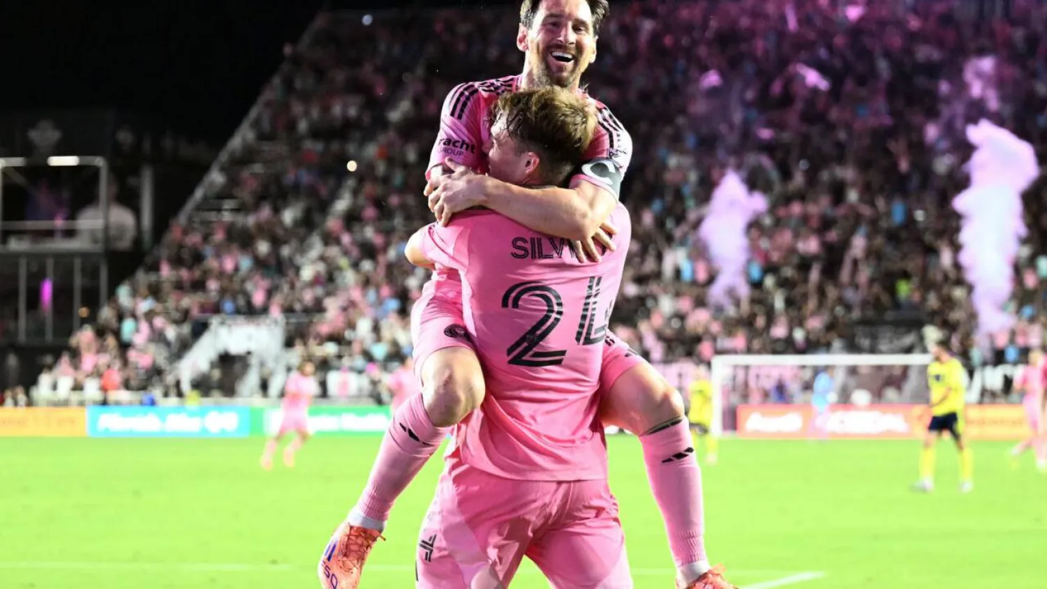 Inter Miami's Argentine star forward Lionel Messi celebrates scoring his second goal with teen countryman Mateo Silvetti, front, in an MLS playoff victory over Nashville that advanced Miami to the second round. CHANDAN KHANNA / AFP
