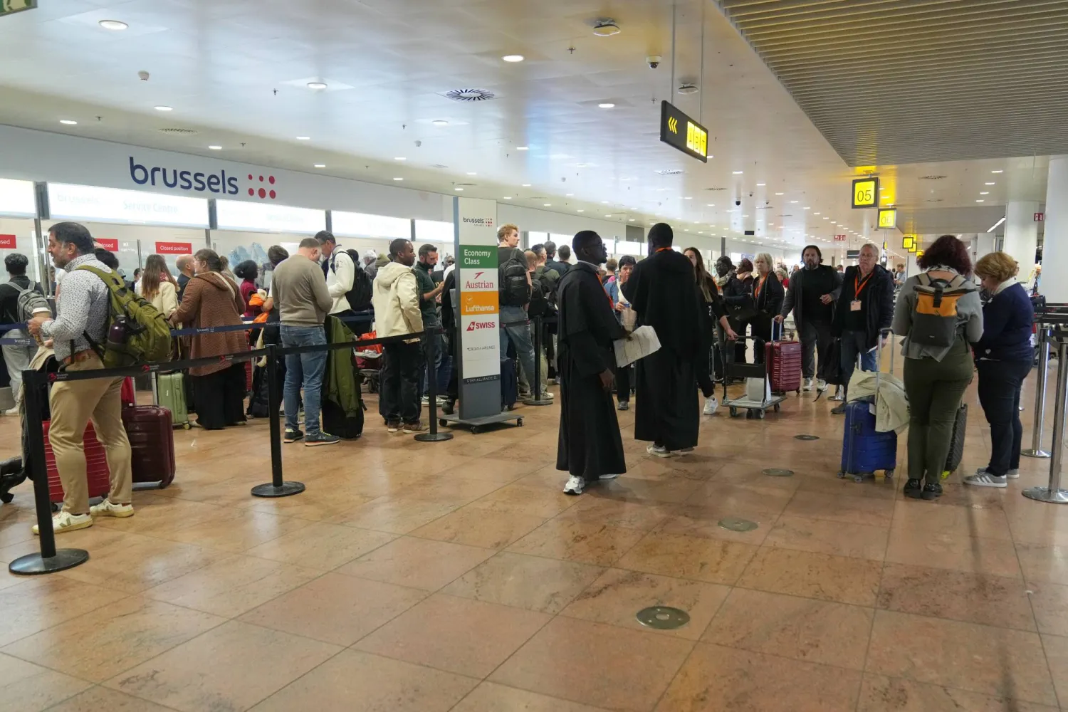 Passengers in the departures terminal after several cancellations and delays due to reported overnight drone activity over Brussels International Airport in Zaventem, Wednesday, Nov. 5, 2025. (AP Photo/Virginia Mayo)