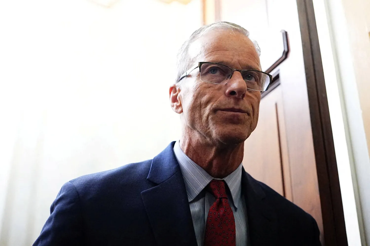 US Senate Majority Leader John Thune (R-SD) looks on outside the Senate Chamber after the vote on the 40th day of the partial government shutdown, in Washington, D.C., US, November 9, 2025. REUTERS/Aaron Schwartz