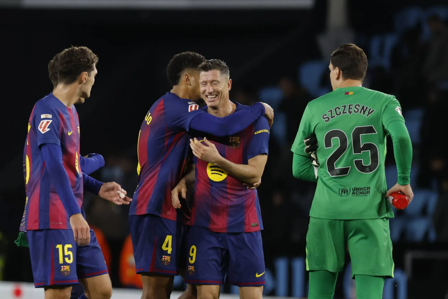Barcelona's Robert Lewandowski celebrates with his teammate Ronald Araujo (C-L) after winning the Spanish LaLiga soccer match between Celta Vigo and FC Barcelona, in Vigo, Spain, 09 November 2025. (EPA)