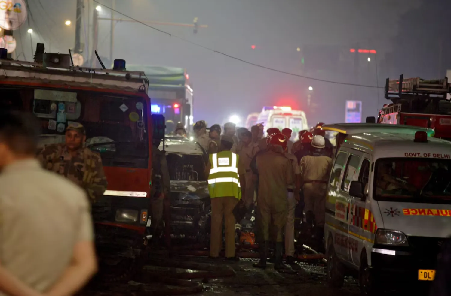 Police and firefighters stand guard at the site of an explosion in the old quarters of Delhi, India, November 10, 2025. REUTERS/Stringer