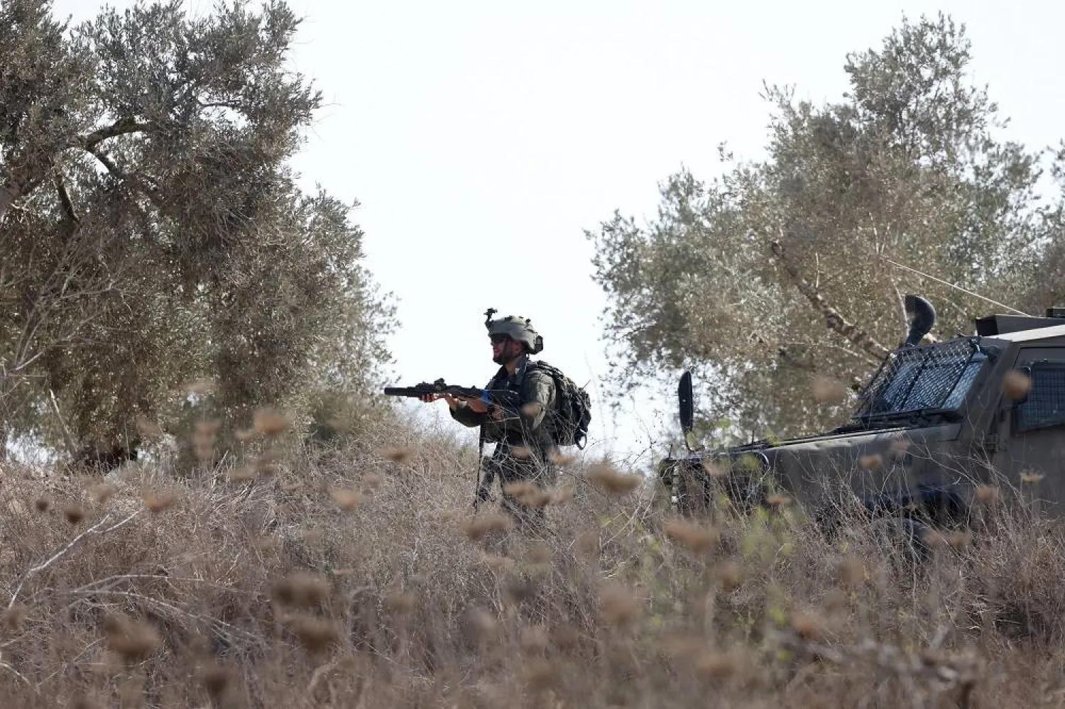 An Israeli soldier takes position during clashes with Palestinian farmers and international activists after they try to reach olive farms outside the village of Beit Led and close to an Israeli settler outpost, near the West Bank city of Qalqilya, 07 November 2025. (EPA)