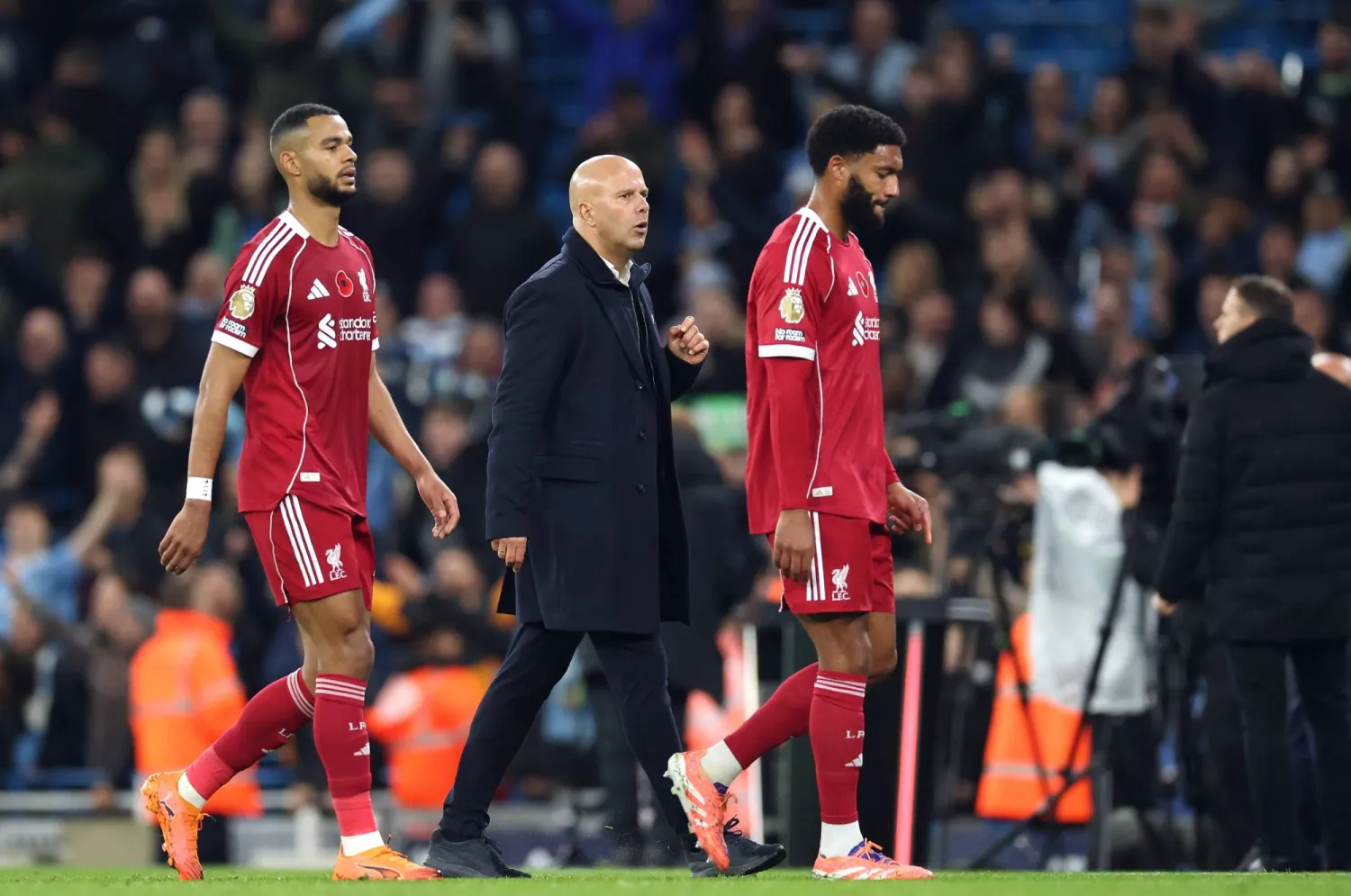 Liverpool's manager Arne Slot (C) and Liverpool's Joe Gomez (R) walk on the pitch after the English Premier League match between Manchester City and Liverpool FC, in Manchester, Britain, 09 November 2025. (EPA)