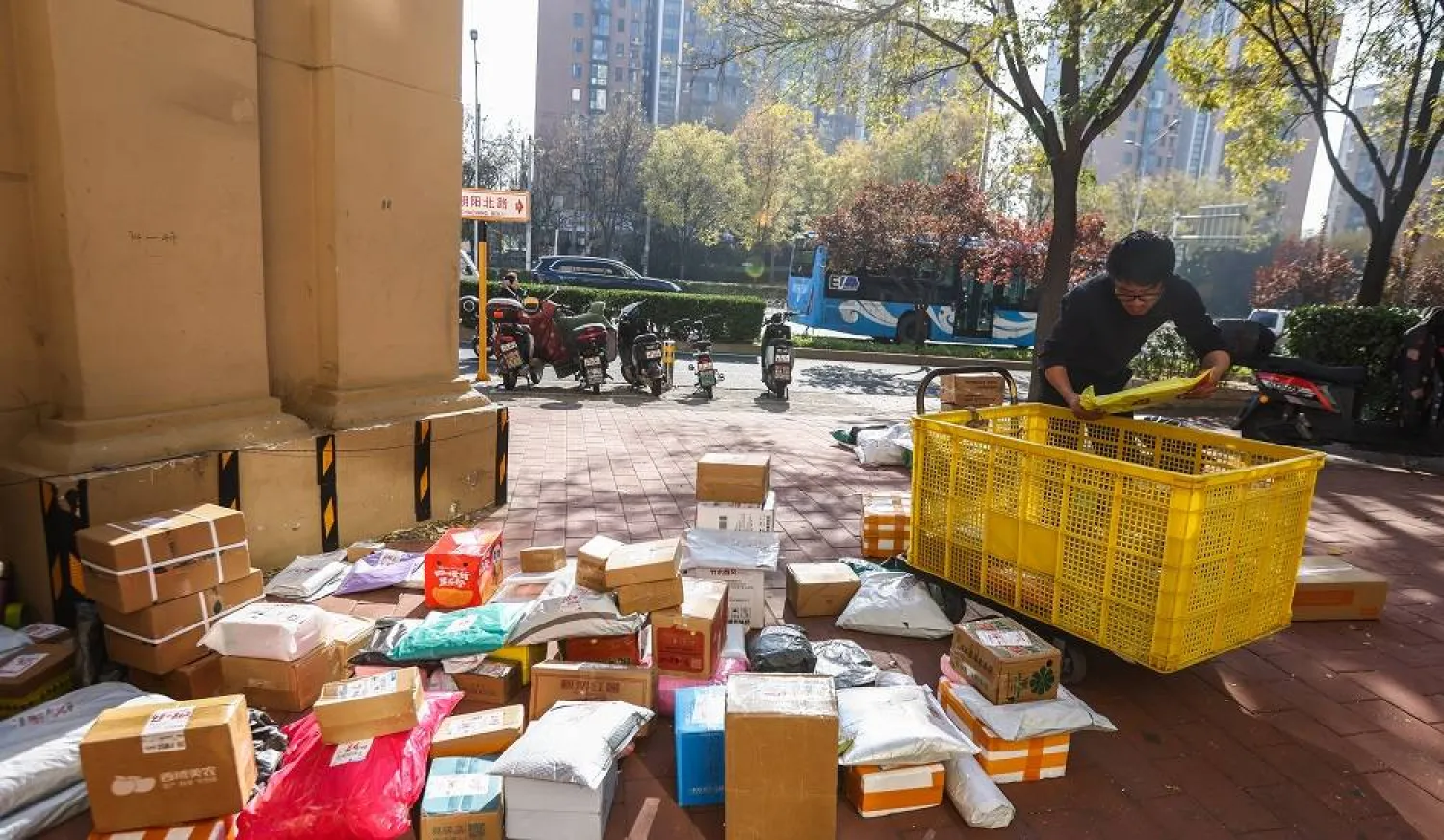 A courier sorts packages for delivery on Singles Day or '11.11' Global Shopping Festival, in Beijing, China, 11 November 2025. (EPA)