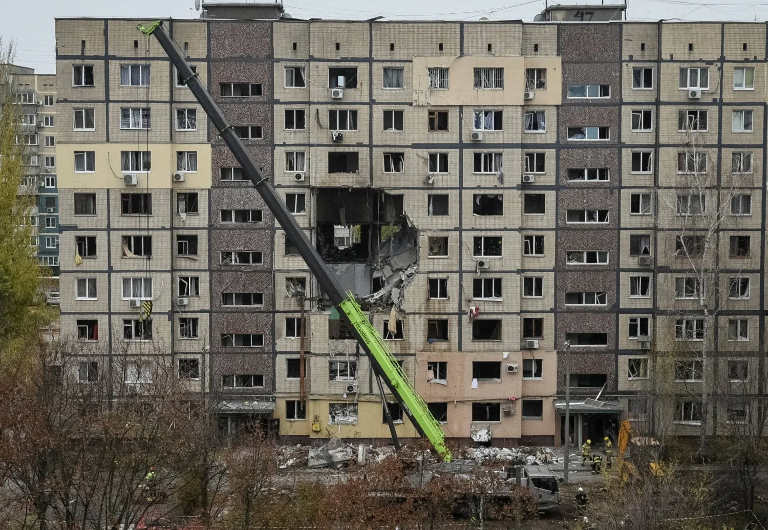 A crane works where several residential units have collapsed after an apartment building was hit during a Russian drone strike, amid Russia's attack on Ukraine, in Dnipro, Ukraine November 8, 2025. (Reuters)