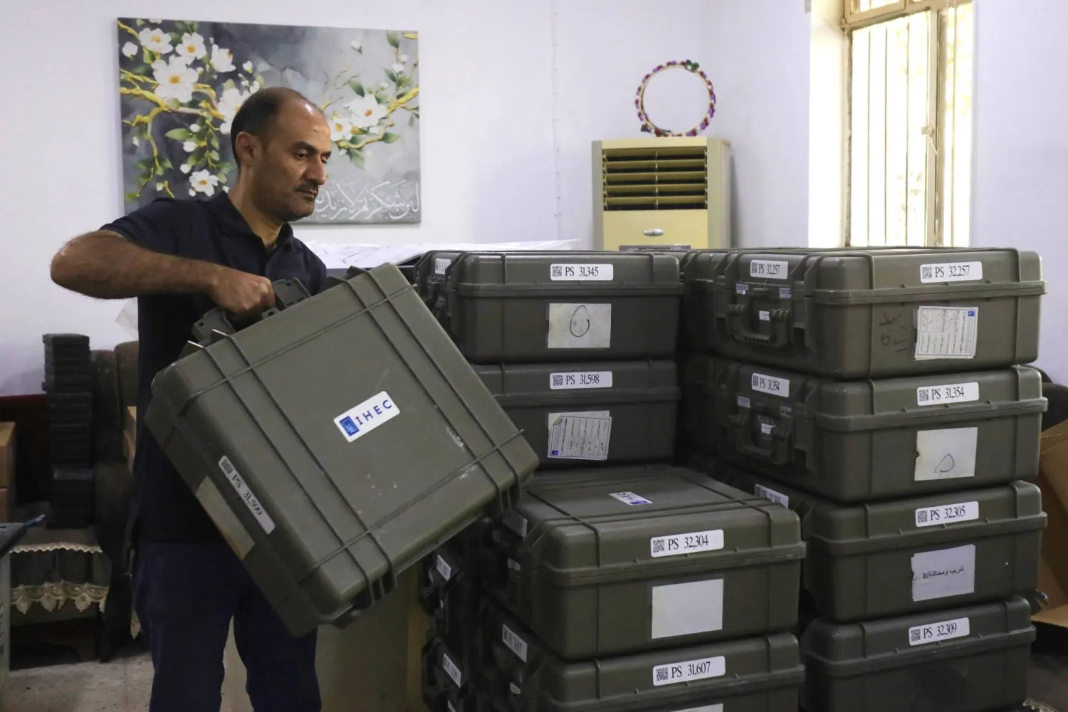  یکی از کارکنان کمیسیون انتخابات عراق تجهیزات مربوط به مراکز رأی‌گیری را در شهر حله، مرکز استان بابل، آماده می‌کند (AFP)
