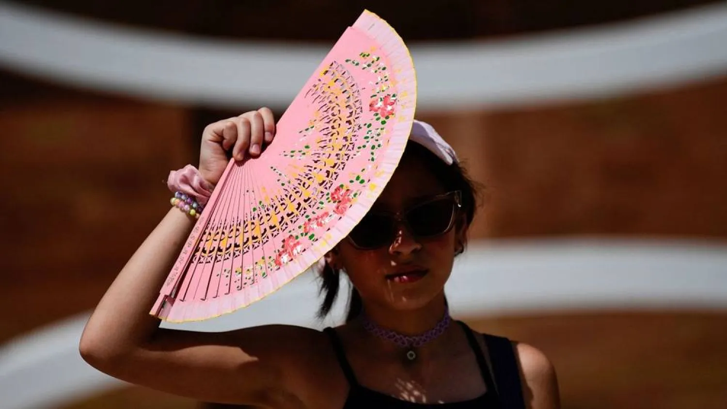  A woman protects herself from the sun with a fan during a heat wave in Seville, Spain. (Getty Images/AFP)