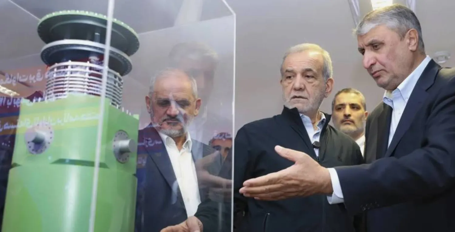 Iran's President Masoud Pezeshkian listens to head of Atomic Energy Organization of Iran Mohammad Eslami as he visits an exhibition of Iran's nuclear achievements, in Tehran, Iran, Wednesday, 9 April 2025. AP