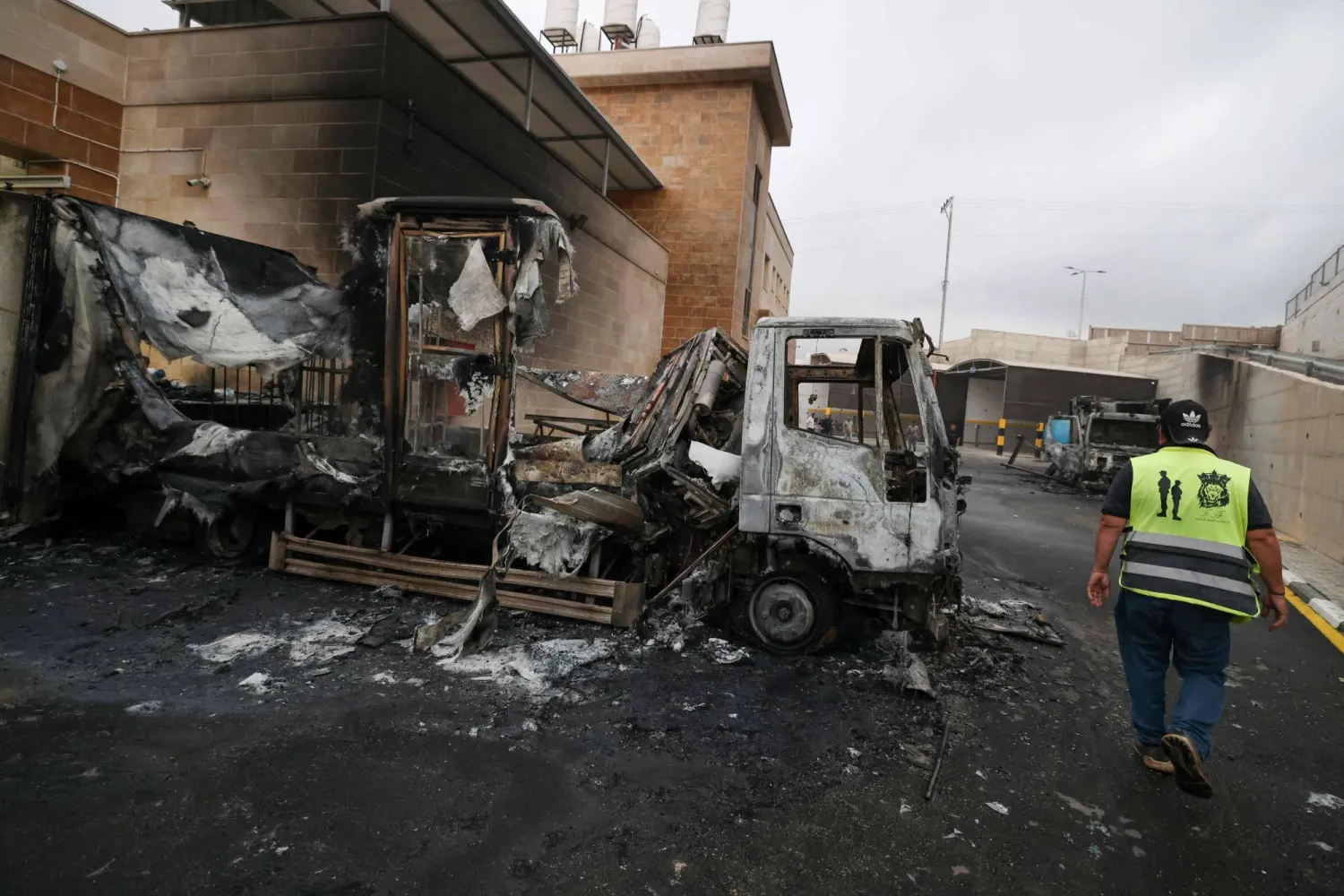A Palestinian man inspects a burnt truck after an Israeli settlers attack in the village of Beit Lid, east of Tulkarm in the occupied West Bank on November 11, 2025. (AFP)