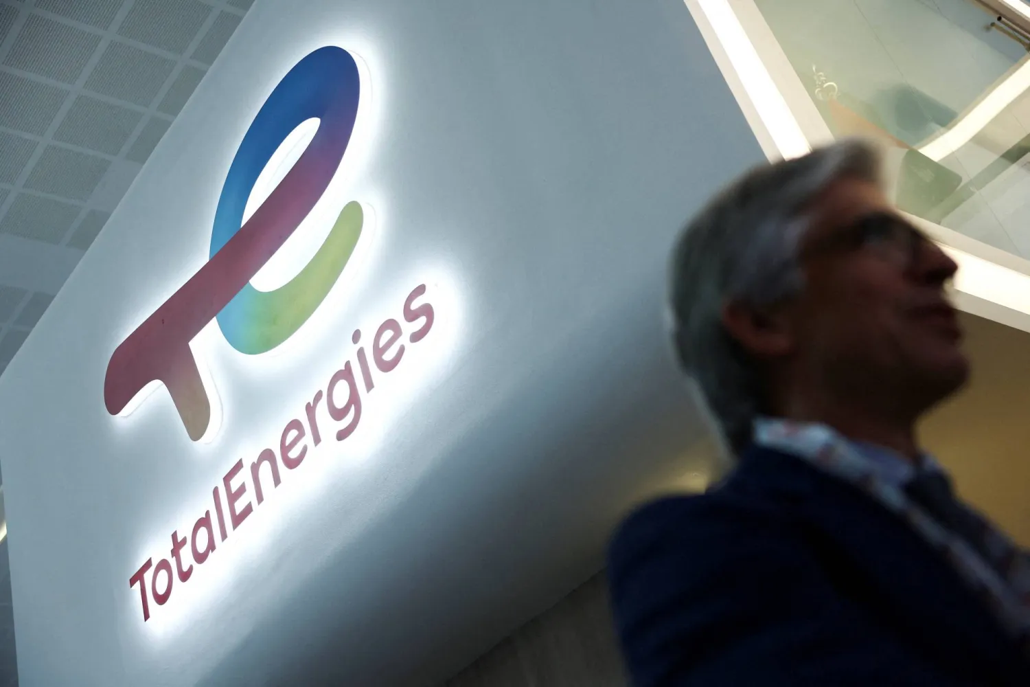 FILE PHOTO: A man walks past a logo of TotalEnergies during the annual energy industry event Abu Dhabi International Petroleum Exhibition and Conference (ADIPEC) in Abu Dhabi, United Arab Emirates, November 3, 2025. REUTERS/Amr Alfiky/File Photo